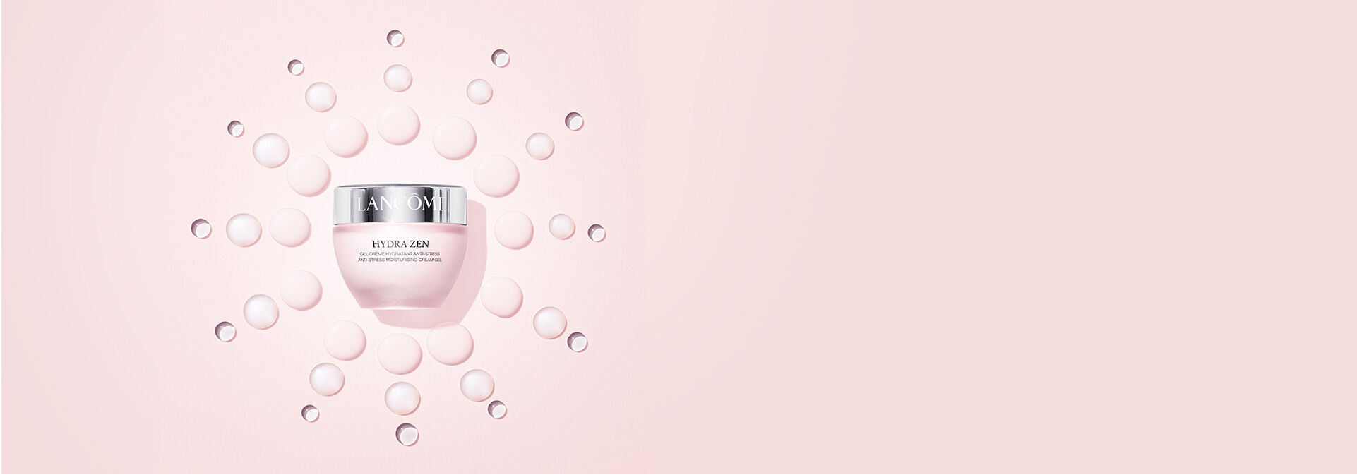 A jar of Lancome Hydra Zen moisturizer surrounded by small droplets on a soft pink background.