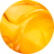 Abstracte close-up van glanzende gele verf met zachte contouren en luchtbelletjes.